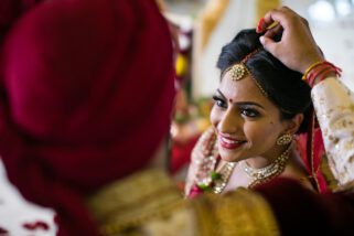 Groom placing Sindoor in the parting of the bride's hair