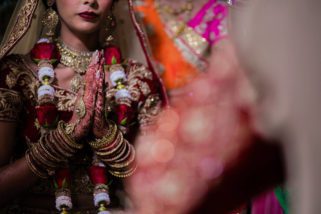 Bride praying during Hindu wedding