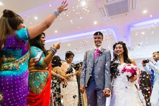 Bride and Groom being showered with confetti