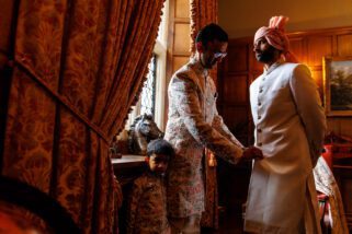 Asian groom getting ready