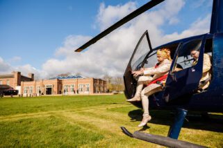 Asian wedding groom arrive by helicopter at Offley Place