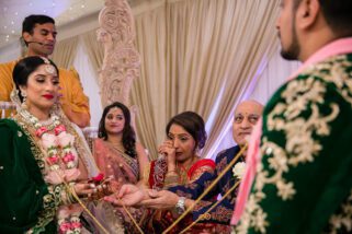 Mother of the bride crying during asian wedding